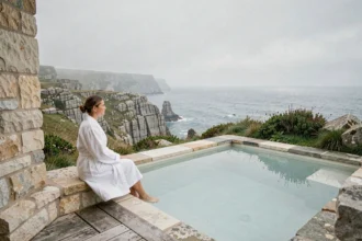 Vue panoramique d'un spa thalasso breton avec piscine d'eau de mer face aux falaises de granit de la côte atlantique